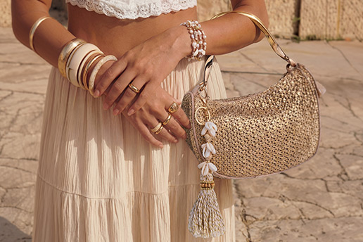 boho outfit, woven bag, beige skirt, bracelets, tassel accessory