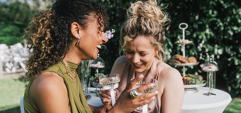 two women, glasses, outdoor party, cake stand, table setting